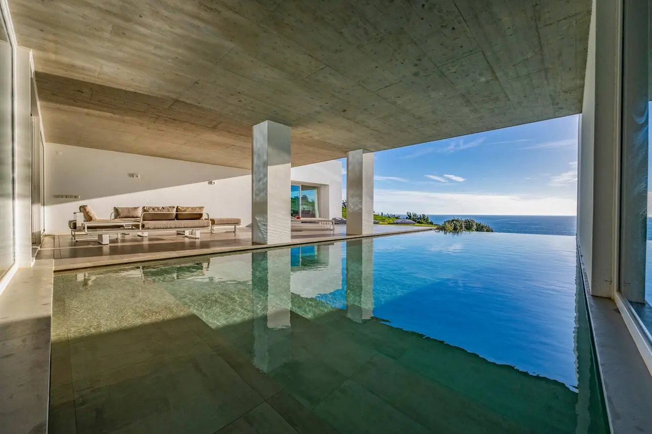Heated pool and sun-loungers above the Atlantic
