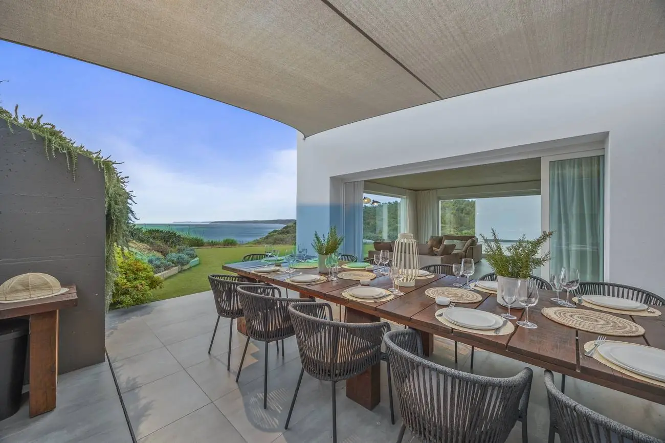 Covered outdoor dining terrace with sea view